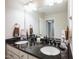 Double vanity bathroom with granite countertops and ample storage at 407 Eagle Ct, Henderson, NC 27536