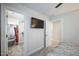 Bedroom with walk-in closet and mounted TV at 407 Eagle Ct, Henderson, NC 27536