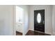Entryway with powder room and black front door at 407 Eagle Ct, Henderson, NC 27536