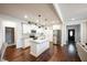 Open concept kitchen with island, stainless steel appliances, and hardwood floors at 407 Eagle Ct, Henderson, NC 27536
