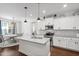 Modern kitchen featuring granite countertops and stainless steel appliances at 407 Eagle Ct, Henderson, NC 27536