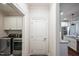 Convenient laundry room with washer, dryer, and overhead cabinets at 407 Eagle Ct, Henderson, NC 27536