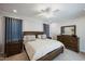 Large bedroom with dark wood furniture and ceiling fan at 407 Eagle Ct, Henderson, NC 27536