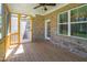 Screened porch with brick wall and wooden flooring at 407 Eagle Ct, Henderson, NC 27536