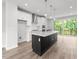 Modern kitchen with island, stainless steel appliances, and hardwood floors at 4505 Mint Leaf Ln, Raleigh, NC 27612