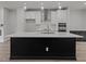 Modern kitchen with large island and stainless steel appliances at 4505 Mint Leaf Ln, Raleigh, NC 27612