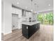Modern kitchen with island, stainless steel appliances, and hardwood floors at 4505 Mint Leaf Ln, Raleigh, NC 27612