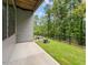 Ground level patio with access to a grassy backyard and wooded area at 4505 Mint Leaf Ln, Raleigh, NC 27612