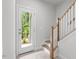 Stairwell with view to back patio and wooded area at 4505 Mint Leaf Ln, Raleigh, NC 27612