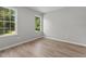 Well-lit bedroom featuring hardwood floors and large windows at 55 Sterling Dr, Franklinton, NC 27525