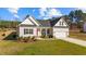 Newly built home with a red front door, two-car garage, and landscaped yard at 80 Black Oak Pl, Spring Lake, NC 28390