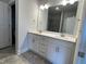 Double vanity bathroom with white cabinets and gray tile floor at 120 Lemon Drop Ln, Franklinton, NC 27525