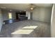 Open concept living room with a view into the kitchen and access to the backyard at 131 Pate Landing Dr, Selma, NC 27576