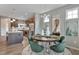 Open concept dining area with a round table and chairs, adjacent to the kitchen at 1432 Cooper St, Sanford, NC 27330