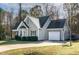 Gray two-story house with a white garage door and landscaped yard at 170 Carrington Ave, Franklinton, NC 27525