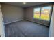 Bright bedroom with gray carpet and a window overlooking the backyard at 186 Pate Landing Dr, Selma, NC 27576