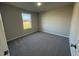 Well-lit bedroom with gray carpet and a large window at 186 Pate Landing Dr, Selma, NC 27576