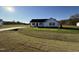 White house with black roof, landscaping, and a grassy yard at 186 Pate Landing Dr, Selma, NC 27576
