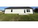 Rear view of a single-story house with a concrete patio at 186 Pate Landing Dr, Selma, NC 27576