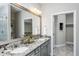 Elegant bathroom with granite countertop double vanity and walk-in closet at 2301 Beeblossom Pl, Fuquay Varina, NC 27526