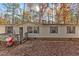 Single-wide manufactured home with a front porch and a yard filled with autumn leaves at 2321 Ridge Run, Lillington, NC 27546