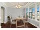 Dining area with hardwood floors and large windows at 237 Sweet Violet Dr, Holly Springs, NC 27540