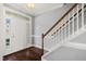 Entryway with hardwood floors, white door, and staircase at 237 Sweet Violet Dr, Holly Springs, NC 27540