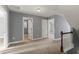 Upstairs hallway with carpet, doors to bedrooms and bathroom at 237 Sweet Violet Dr, Holly Springs, NC 27540