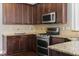 Modern kitchen with stainless steel appliances and granite counters at 237 Sweet Violet Dr, Holly Springs, NC 27540