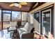 Enjoy this screened porch with wicker furniture and double doors leading outside at 2517 Shepherd Valley St, Raleigh, NC 27610