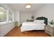 Bedroom with green velvet headboard, hardwood floors, and ample natural light at 2618 Wade Ave, Raleigh, NC 27607