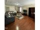 Spacious living area with hardwood floors and an L-shaped sofa at 2907 S Roxboro St, Durham, NC 27707