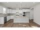 Modern kitchen with white cabinets, granite countertops, and island at 319 Travelers Ct, Mebane, NC 27302