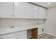 Laundry room with white cabinets and patterned flooring at 319 Travelers Ct, Mebane, NC 27302