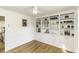 White built-in shelving unit with a ceiling fan and hardwood floors at 3540 Chelsea Dr, Rocky Mount, NC 27803