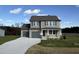 Two-story house with gray siding, gray double garage doors, and a stone accent at 36 Holly Grove Ln, Lillington, NC 27546