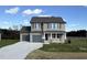 Two-story house with gray siding, gray double garage doors, and a stone accent at 36 Holly Grove Ln, Lillington, NC 27546