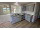 Modern kitchen with gray cabinets, granite countertops, and stainless steel appliances at 36 Holly Grove Ln, Lillington, NC 27546