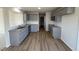 Modern kitchen with gray cabinets, granite countertops, and LVP flooring at 36 Holly Grove Ln, Lillington, NC 27546