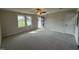 Bright living room with neutral carpeting and access to the front entrance at 36 Holly Grove Ln, Lillington, NC 27546