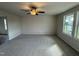 Living room with neutral carpeting and view of the backyard at 36 Holly Grove Ln, Lillington, NC 27546