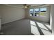 Spacious main bedroom with neutral carpeting and multiple windows at 36 Holly Grove Ln, Lillington, NC 27546
