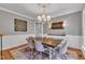 Formal dining room with chandelier, hardwood floors, and seating for six at 4105 Summer Brook Dr, Apex, NC 27539