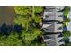 Aerial view of homes near a pond with lush trees at 4129 Gardenlake Dr, Raleigh, NC 27612