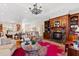 Open living room with built-in shelving, fireplace, and hardwood floors at 4129 Gardenlake Dr, Raleigh, NC 27612