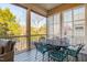 Screened porch with table and chairs, offering backyard views at 4129 Gardenlake Dr, Raleigh, NC 27612