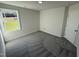 Spacious bedroom with grey carpet and a large window at 45 New Bethel Ct, Lillington, NC 27546