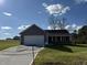 Gray exterior ranch home with attached garage and landscaped lawn at 45 New Bethel Ct, Lillington, NC 27546