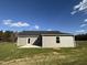 Rear view of house showcasing a patio and grassy yard at 45 New Bethel Ct, Lillington, NC 27546