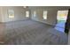 Spacious living room with grey carpet, vaulted ceiling, and lots of natural light at 45 New Bethel Ct, Lillington, NC 27546